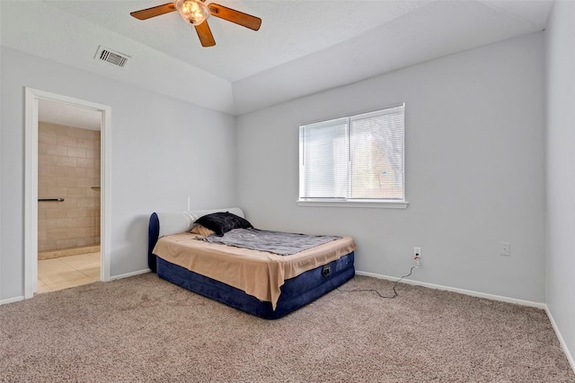 bedroom featuring ceiling fan, lofted ceiling, connected bathroom, and carpet