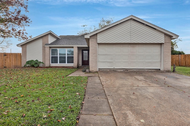 mid-century modern home with a front lawn, fence, concrete driveway, an attached garage, and brick siding