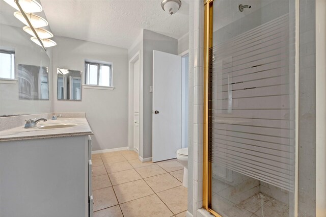 bathroom with tile patterned flooring, an enclosed shower, a textured ceiling, and a wealth of natural light