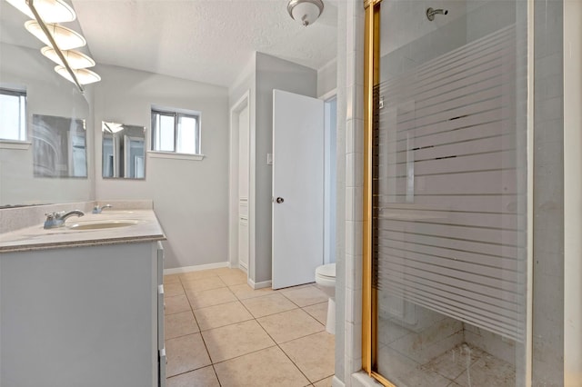 bathroom featuring a shower with shower door, tile patterned flooring, vanity, toilet, and a textured ceiling