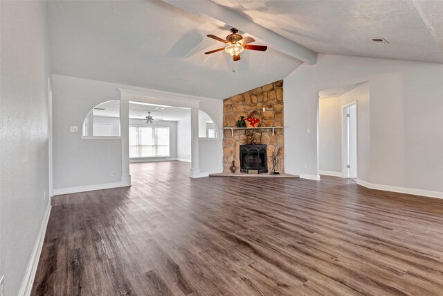 unfurnished living room featuring vaulted ceiling with beams, ceiling fan, a fireplace, and dark hardwood / wood-style floors