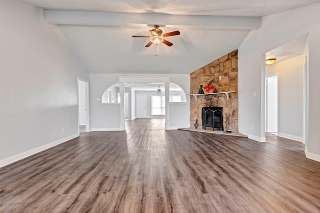 unfurnished living room with lofted ceiling with beams, ceiling fan, hardwood / wood-style flooring, and a fireplace