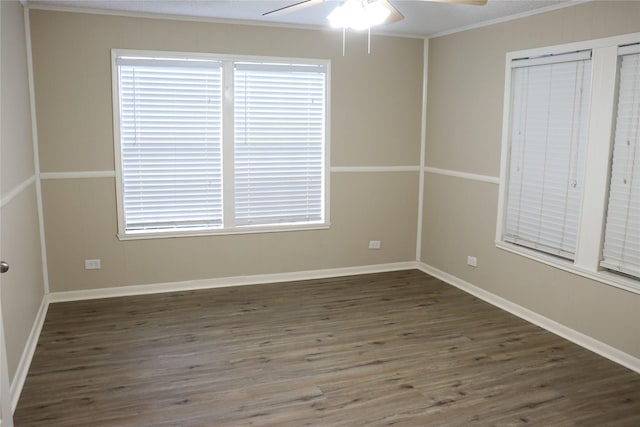 spare room featuring ceiling fan, ornamental molding, and dark wood-type flooring