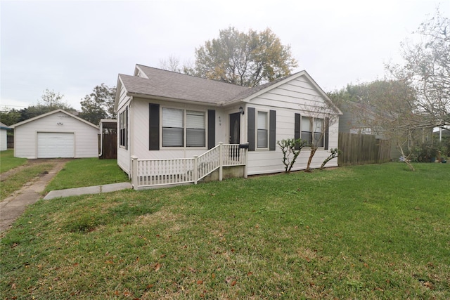 view of front of home with an outbuilding, a garage, and a front lawn