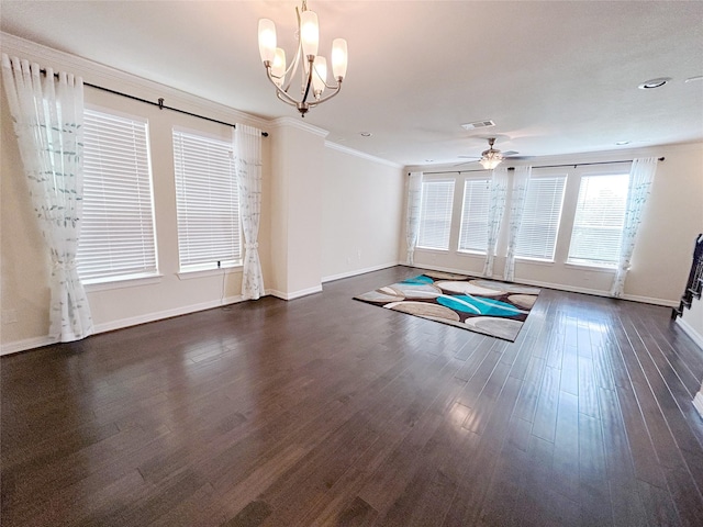 empty room with dark hardwood / wood-style floors, ornamental molding, and ceiling fan with notable chandelier