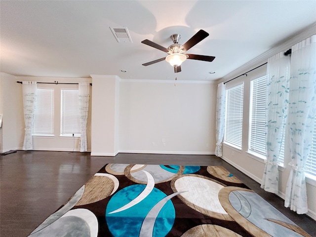 living area featuring plenty of natural light, ceiling fan, dark hardwood / wood-style flooring, and ornamental molding