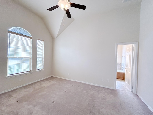 carpeted spare room with vaulted ceiling and ceiling fan