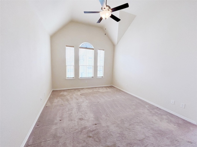 carpeted spare room featuring ceiling fan and lofted ceiling