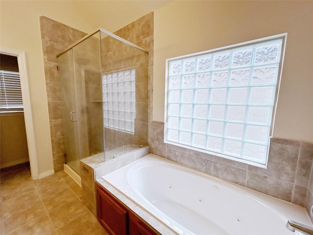 bathroom featuring tile patterned floors and shower with separate bathtub