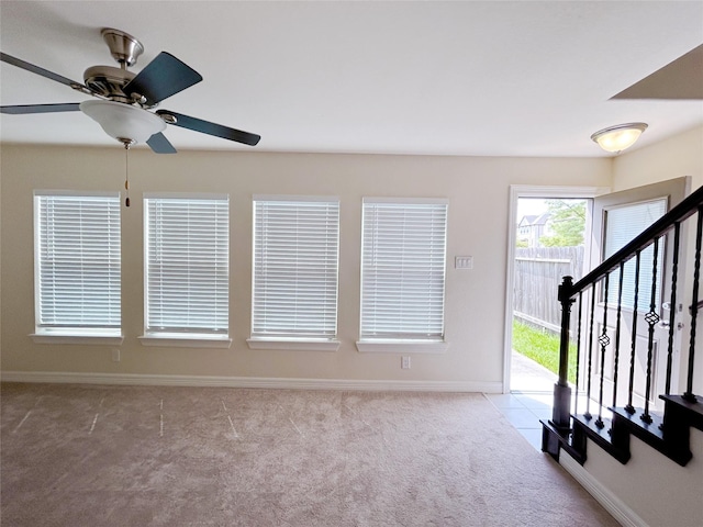 unfurnished living room with light carpet and ceiling fan