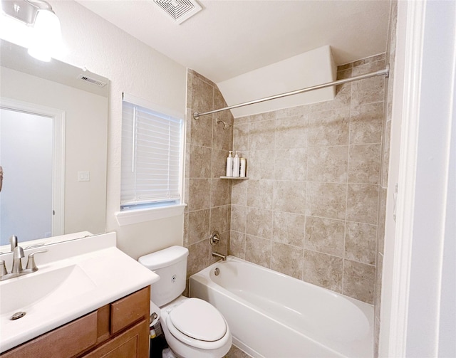 full bathroom featuring toilet, vanity, and tiled shower / bath