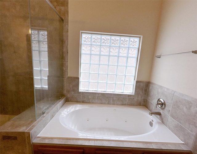 bathroom with a bathing tub and a healthy amount of sunlight