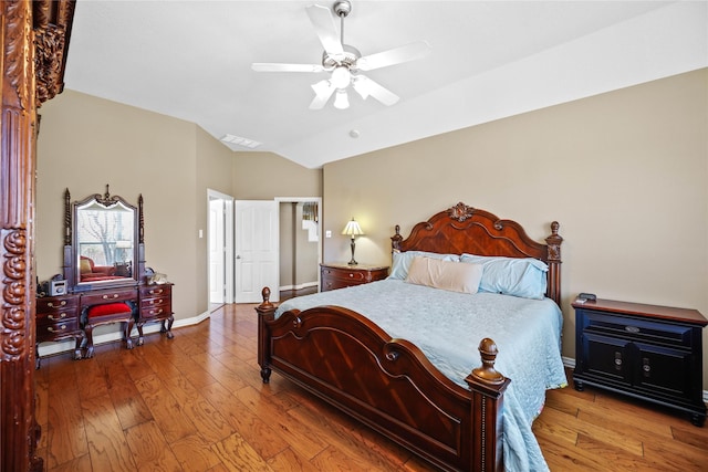 bedroom with hardwood / wood-style floors, vaulted ceiling, and ceiling fan