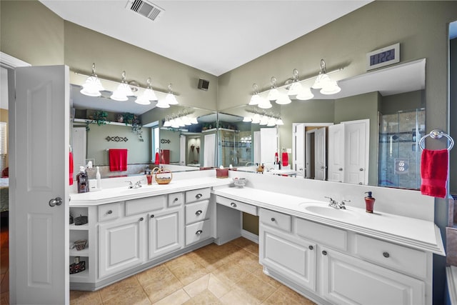 bathroom with tile patterned flooring, vanity, and a shower with shower door