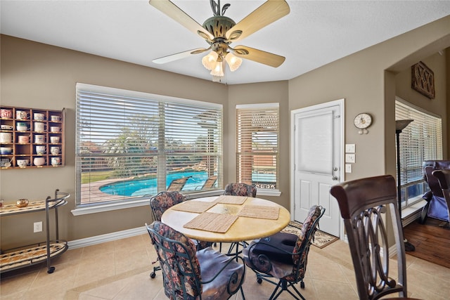 tiled dining room with ceiling fan