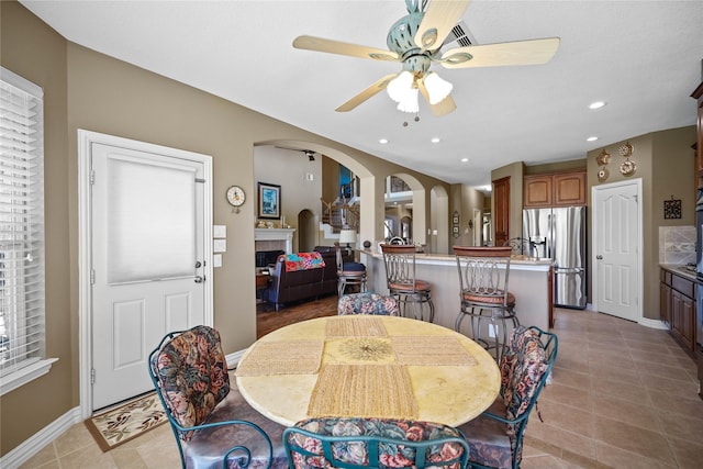 dining room with ceiling fan and light tile patterned floors