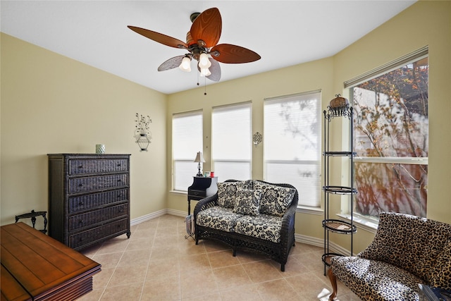 living area featuring ceiling fan and light tile patterned floors