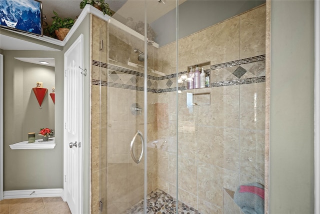 bathroom with tile patterned flooring and an enclosed shower