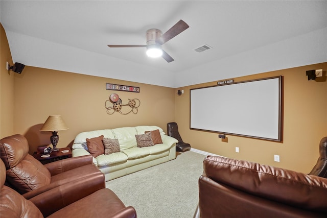 home theater room featuring ceiling fan and carpet floors