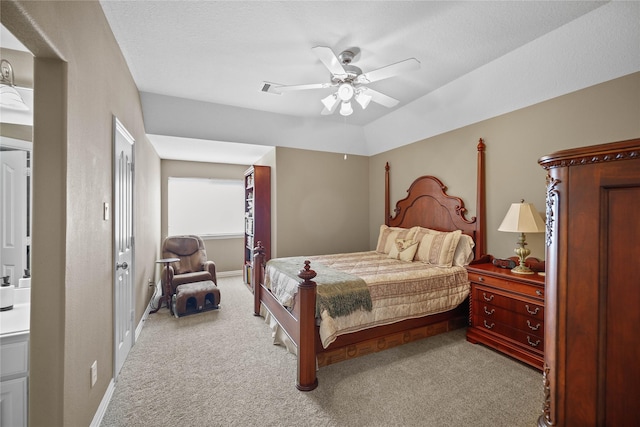 carpeted bedroom with ceiling fan and a textured ceiling