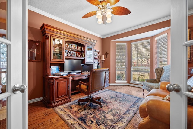 office area with a textured ceiling, hardwood / wood-style flooring, ceiling fan, and crown molding