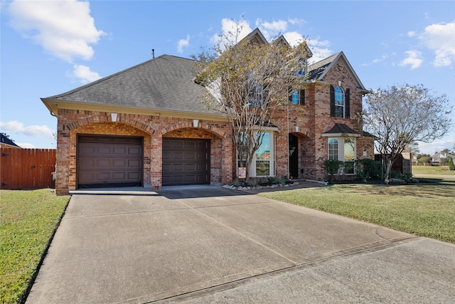 view of front of property with a front lawn and a garage