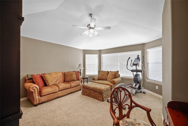 carpeted living room featuring ceiling fan and vaulted ceiling