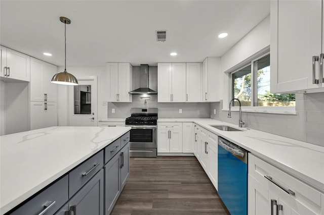 kitchen with wall chimney exhaust hood, white cabinetry, and stainless steel appliances