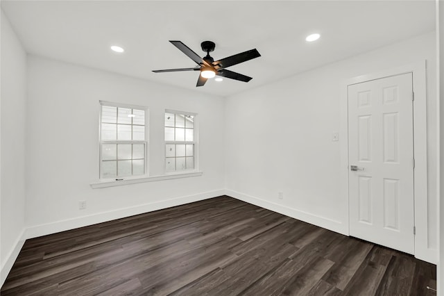 unfurnished room with ceiling fan and dark wood-type flooring