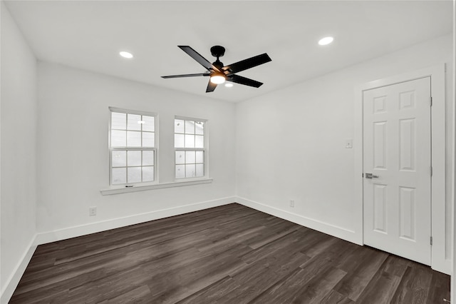 unfurnished room with ceiling fan and dark wood-type flooring