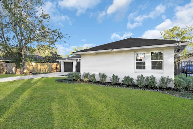 view of property exterior featuring a garage and a lawn