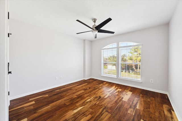 spare room with dark hardwood / wood-style floors and ceiling fan