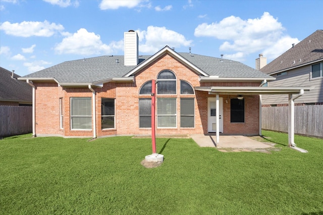 back of property featuring a lawn and a patio area