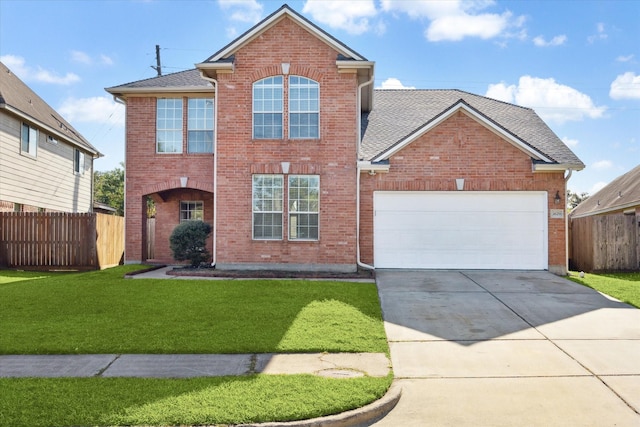 front of property featuring a front yard and a garage