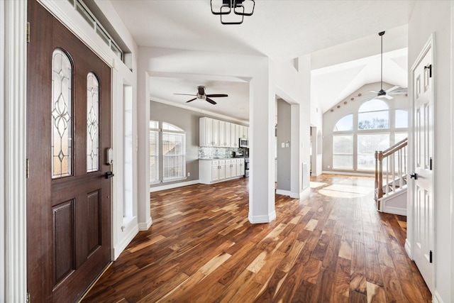 foyer entrance with dark hardwood / wood-style floors, ceiling fan, lofted ceiling, and crown molding