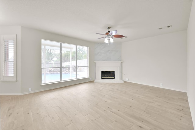 unfurnished living room with light hardwood / wood-style flooring and ceiling fan