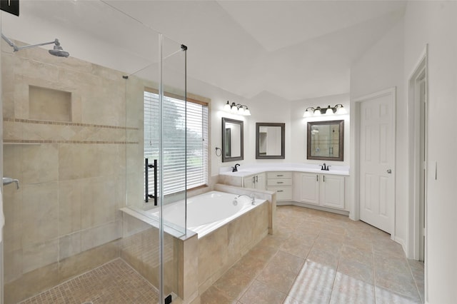 bathroom featuring lofted ceiling, vanity, and shower with separate bathtub