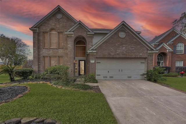 front of property featuring a garage and a lawn