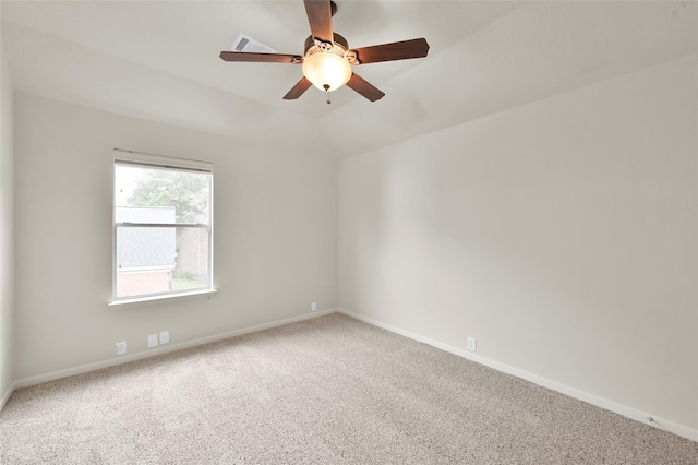 spare room with lofted ceiling, carpet floors, and ceiling fan