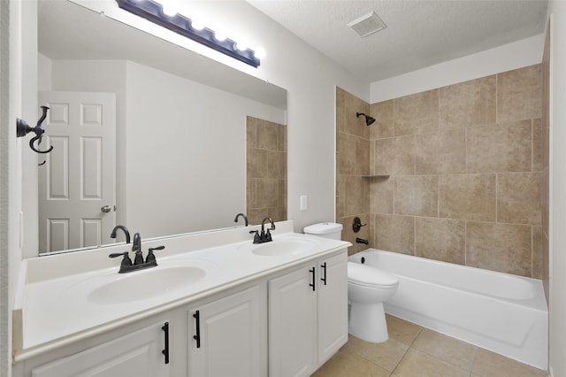 full bathroom featuring tiled shower / bath combo, vanity, tile patterned flooring, toilet, and a textured ceiling