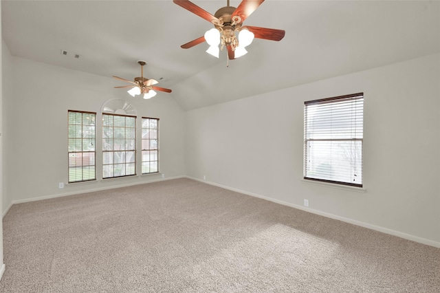 empty room with plenty of natural light, carpet flooring, lofted ceiling, and ceiling fan