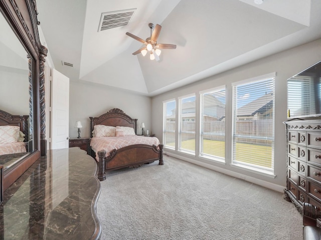 carpeted bedroom with ceiling fan and high vaulted ceiling