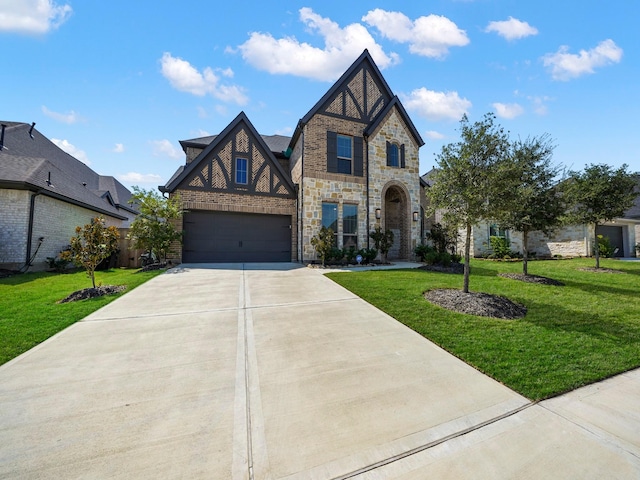 english style home featuring a front yard and a garage