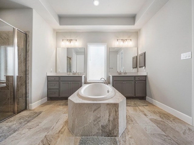 bathroom featuring vanity, a raised ceiling, and shower with separate bathtub