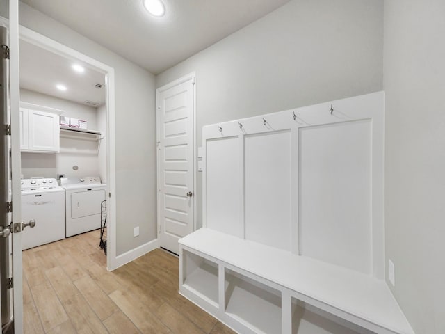 mudroom featuring washing machine and dryer and light hardwood / wood-style floors