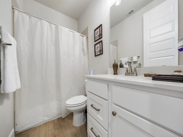 bathroom featuring hardwood / wood-style floors, vanity, and toilet