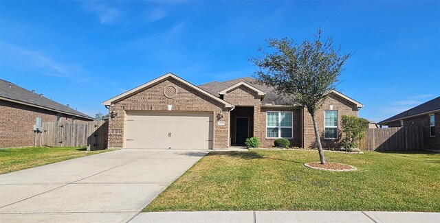 single story home featuring a garage and a front yard