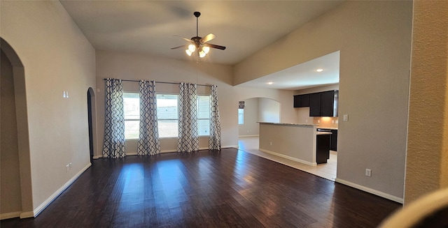 unfurnished living room with dark wood-type flooring and ceiling fan