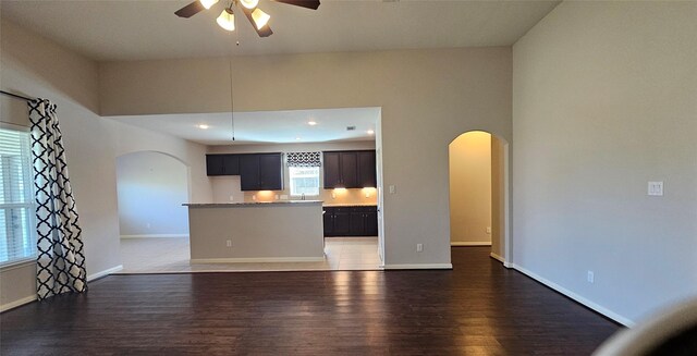 unfurnished living room featuring ceiling fan and dark hardwood / wood-style floors