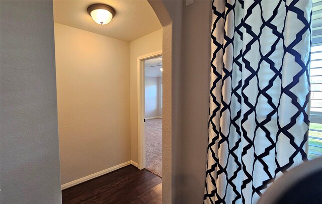 hallway with dark hardwood / wood-style flooring